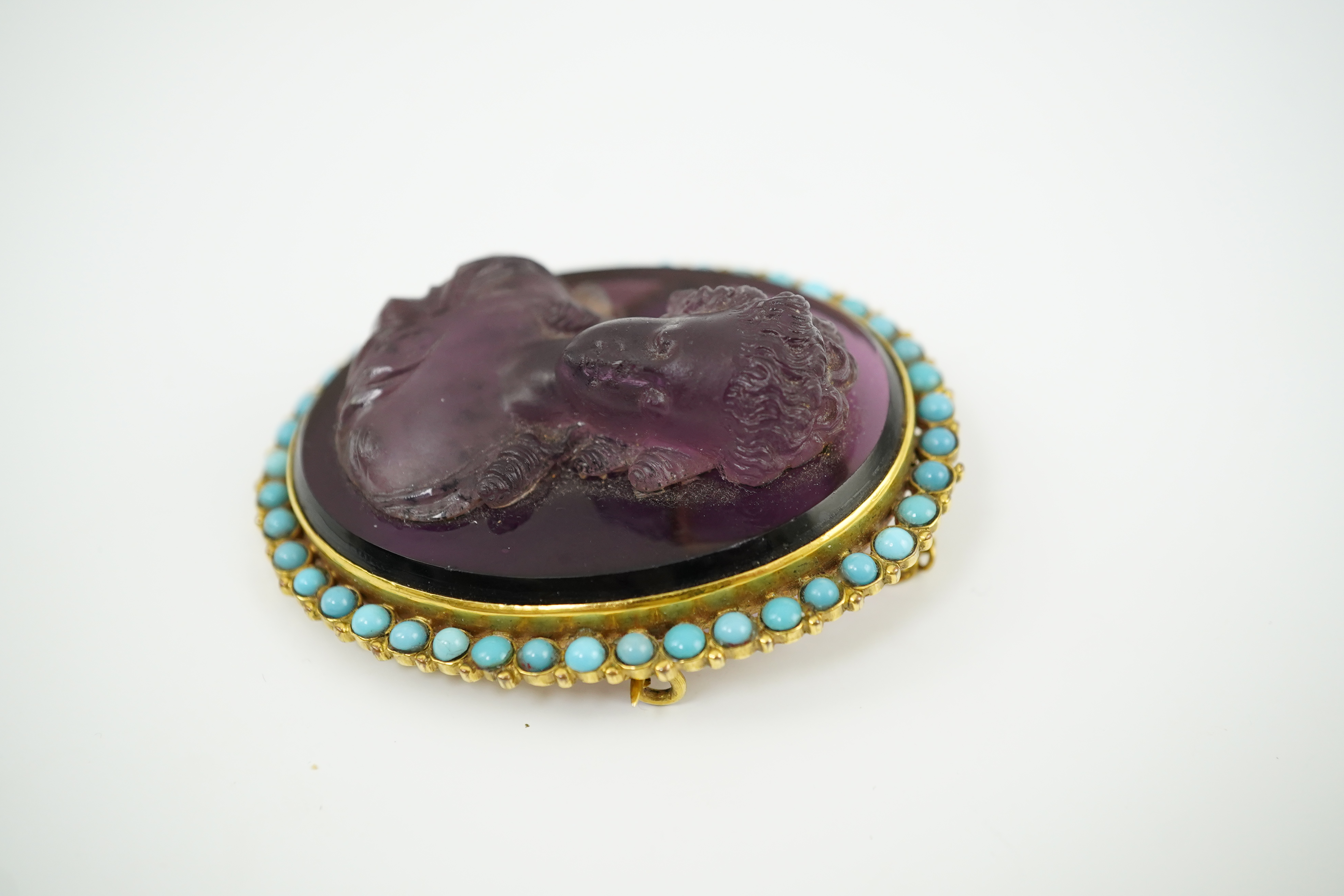 A late 19th/early 20th century gold and turquoise enamel? mounted oval amethyst paste set brooch